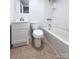 Bathroom features a shower-tub combo with tile surround, vanity with storage, and a toilet at 512 Hall St, Salisbury, NC 28144