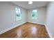 This bedroom offers natural light through two windows, hardwood floors, and neutral paint at 512 Hall St, Salisbury, NC 28144