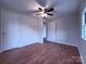 This bedroom offers a ceiling fan, hardwood floors, neutral paint, and ample closet space at 512 Hall St, Salisbury, NC 28144
