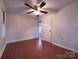 This bedroom features hardwood floors, neutral paint, closet space, and a ceiling fan at 512 Hall St, Salisbury, NC 28144