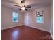 This bedroom offers natural light, hardwood floors, neutral paint, and a ceiling fan at 512 Hall St, Salisbury, NC 28144
