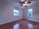 This bedroom features hardwood floors, two windows for plenty of natural light, and ceiling fan at 512 Hall St, Salisbury, NC 28144