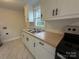 Close up of kitchen sink with wood countertops, stainless steel appliances, and white cabinets at 512 Hall St, Salisbury, NC 28144