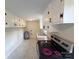 Galley kitchen with updated appliances, white cabinets, and wood countertops at 512 Hall St, Salisbury, NC 28144