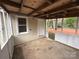 Spacious screened porch featuring concrete flooring and open-beam ceiling for outdoor enjoyment at 512 Hall St, Salisbury, NC 28144