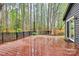 Relaxing backyard with string lights over the deck and privacy provided by mature trees at 6500 Wealdstone Ct, Mint Hill, NC 28227