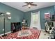 Bedroom with green walls, ceiling fan, large window, and a comfortable workspace at 6500 Wealdstone Ct, Mint Hill, NC 28227