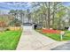 Inviting home with a well-maintained lawn and long driveway leading to an attached garage at 6500 Wealdstone Ct, Mint Hill, NC 28227