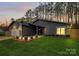 Charming home with a manicured lawn, stone accents, and beautiful landscape lighting at 6500 Wealdstone Ct, Mint Hill, NC 28227