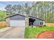 Charming home featuring stone accents, an attached garage, and a well-manicured lawn at 6500 Wealdstone Ct, Mint Hill, NC 28227