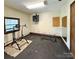 Gym space in garage with equipment including adjustable bench and weightlifting equipment at 6500 Wealdstone Ct, Mint Hill, NC 28227