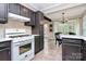Kitchen area showcases modern appliances, stylish tile backsplash, and adjacent dining space at 6500 Wealdstone Ct, Mint Hill, NC 28227