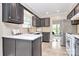 Cozy kitchen with dark cabinets, tile backsplash, and view into the dining area at 6500 Wealdstone Ct, Mint Hill, NC 28227