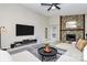 Cozy living area with stone fireplace, a comfortable sectional, and a ceiling fan at 6500 Wealdstone Ct, Mint Hill, NC 28227
