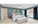 Serene main bedroom with calm blue walls, neutral furniture, and natural light at 6500 Wealdstone Ct, Mint Hill, NC 28227