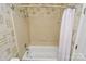 Bathroom showcasing a tiled shower with a white shower curtain and patterned wallpaper at 6500 Wealdstone Ct, Mint Hill, NC 28227