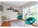 Sunlit sitting area with unique chairs, stylish decor, and wood flooring at 6500 Wealdstone Ct, Mint Hill, NC 28227