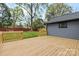 A spacious wood deck overlooks the lush, green backyard at 7009 Wrentree Dr, Charlotte, NC 28210