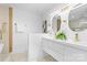 Modern bathroom with dual sinks, stylish mirrors, and luxury gold fixtures at 7009 Wrentree Dr, Charlotte, NC 28210
