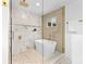 Spa-like bathroom with standalone tub, glass shower, and elegant gold finishes at 7009 Wrentree Dr, Charlotte, NC 28210