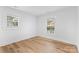 Bright bedroom featuring wood flooring and natural light from two windows at 7009 Wrentree Dr, Charlotte, NC 28210