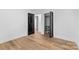 Light bedroom with wood floors, closet, and ensuite bathroom entrance at 7009 Wrentree Dr, Charlotte, NC 28210