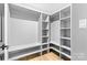 Spacious walk-in closet with custom shelving and rods for optimal organization at 7009 Wrentree Dr, Charlotte, NC 28210