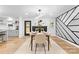 Contemporary dining room featuring designer lighting and accent wall at 7009 Wrentree Dr, Charlotte, NC 28210