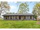 Charming single-story home featuring a well-manicured lawn, stylish shutters, and a welcoming front entrance at 7009 Wrentree Dr, Charlotte, NC 28210