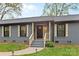 Attractive front entrance featuring detailed shutters and well-maintained landscaping, offering great curb appeal at 7009 Wrentree Dr, Charlotte, NC 28210
