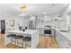 Contemporary kitchen featuring marble island, stainless appliances, and bar seating at 7009 Wrentree Dr, Charlotte, NC 28210