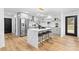 Modern kitchen with marble island, stainless steel appliances, and gray cabinetry at 7009 Wrentree Dr, Charlotte, NC 28210