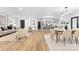 Open-concept living space showcasing hardwood floors, modern lighting, and a seamless flow into the kitchen and dining areas at 7009 Wrentree Dr, Charlotte, NC 28210