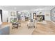 Open-concept living space with modern decor, hardwood floors, and seamless transition to the kitchen and dining areas at 7009 Wrentree Dr, Charlotte, NC 28210