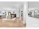 Bright, open-concept living room with fireplace, dining area, and hardwood floors at 7009 Wrentree Dr, Charlotte, NC 28210