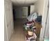 Hallway of a basement with tile flooring, white walls, access to rooms and lots of items and accessories at 7122 Pyramid Rd, Hickory, NC 28602