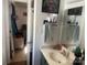 Small bathroom featuring a mirror, small sink, and open doorway to bedroom at 7122 Pyramid Rd, Hickory, NC 28602