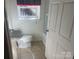 Cozy bathroom featuring a toilet, sink, and shower/tub combination, enhanced by a window with polka dot valance at 7122 Pyramid Rd, Hickory, NC 28602