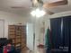 A bedroom with a ceiling fan, built-in shelving, and storage, bathed in natural light from the window at 7122 Pyramid Rd, Hickory, NC 28602