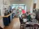 Bright dining room filled with clutter and boxes, featuring hardwood floors at 7122 Pyramid Rd, Hickory, NC 28602