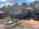 The side of a ranch style home with light colored siding, a driveway, landscaping and a dark SUV at 7122 Pyramid Rd, Hickory, NC 28602
