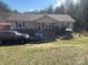 A ranch style home with light colored siding and a front yard with green grass, trees and a playground at 7122 Pyramid Rd, Hickory, NC 28602