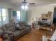 Cozy living room featuring comfortable seating and natural light, complemented by hardwood floors at 7122 Pyramid Rd, Hickory, NC 28602