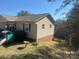 A ranch style home with light colored siding showing green shutters, and a small brick elevation under the siding at 7122 Pyramid Rd, Hickory, NC 28602