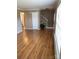 Spacious living area with hardwood floors, staircase, and natural light from large windows at 7307 Meadowland Dr, Charlotte, NC 28215