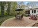 Paved patio area with outdoor seating surrounded by mature trees and landscaping at 7710 Epping Forest Dr, Huntersville, NC 28078