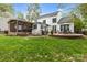 Expansive backyard featuring a stone patio, screened-in porch, and lush green lawn at 7710 Epping Forest Dr, Huntersville, NC 28078