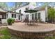 Spacious backyard featuring a brick patio with outdoor dining set, perfect for entertaining at 7710 Epping Forest Dr, Huntersville, NC 28078