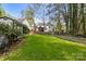 Spacious backyard with a storage shed, tall trees, and plenty of green space at 7710 Epping Forest Dr, Huntersville, NC 28078