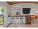 Home bar area with seating and a pass-through window to the kitchen at 7710 Epping Forest Dr, Huntersville, NC 28078